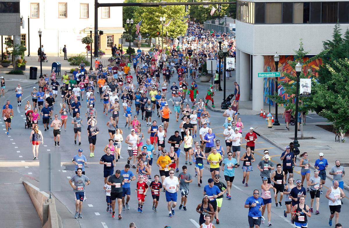 Runners ran down East Vine Street during the 42nd annual Fourth of July Bluegrass 10,000 road race through downtown Lexington on Wednesday. A total of 3,360 runners registered for this year's race.