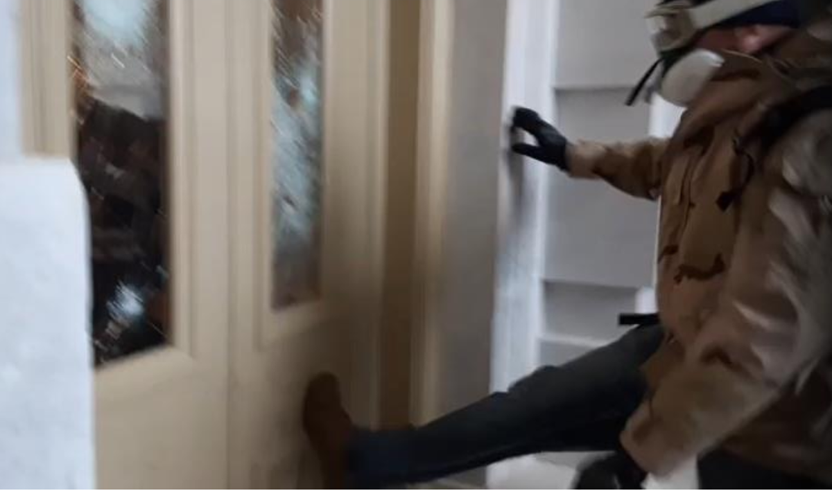An FBI agent said in a court statement that this photo shows Joseph Howe of Kentucky kicking the door to the Senate wing in the U.S. Capitol on Jan. 6, 2021 as he and others allegedly interrupted work to certify Joe Biden as president.