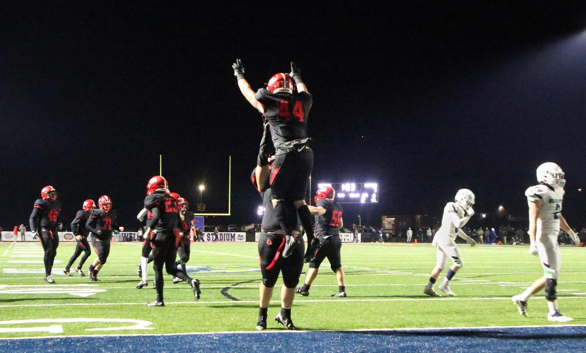 Scott County’s Luke Colvin (44) gets a celebratory lift from Scott County’s Merrick Bowen (75) after Colvin scored a touchdown Friday against Great Crossing.