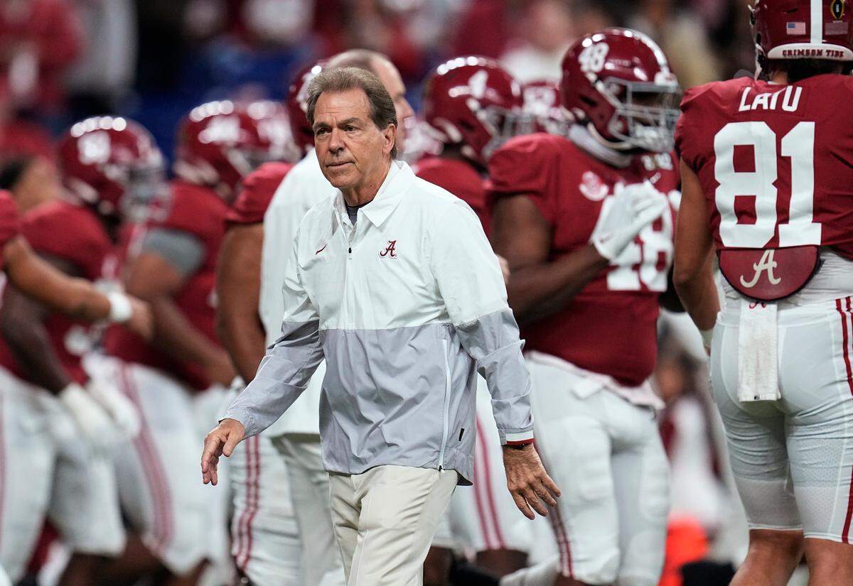 FILE - Alabama coach Nick Saban watches players warm up for the College Football Playoff championship NCAA football game against Georgia on Jan. 10, 2022, in Indianapolis. Saban is concerned about the current state of college football. He recently told The Associated Press “I don’t think what we’re doing right now is a sustainable model.” (AP Photo/Paul Sancya, File)