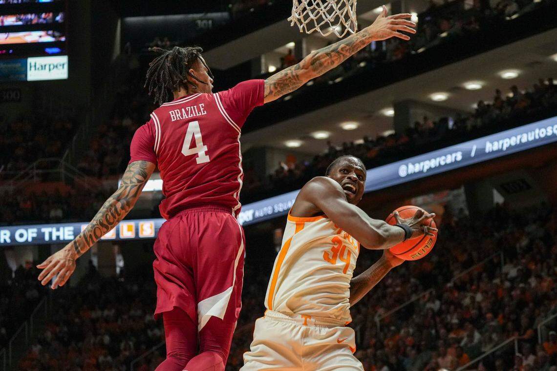 Tennessee forward Felix Okpara (34) ducks away from Arkansas forward Trevon Brazile (4) during a college basketball game between Tennessee and Arkansas held at Thompson-Boling Arena at Food City Center in Knoxville, Tenn., on Saturday, January 4, 2025. Tennessee won 76-52 against Arkansas.