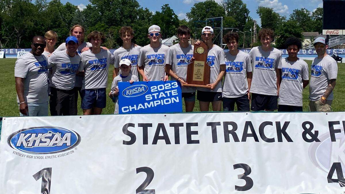The Walton-Verona boys’ team poses with its state championship trophy after winning Thursday’s Class A meet at the University of Kentucky