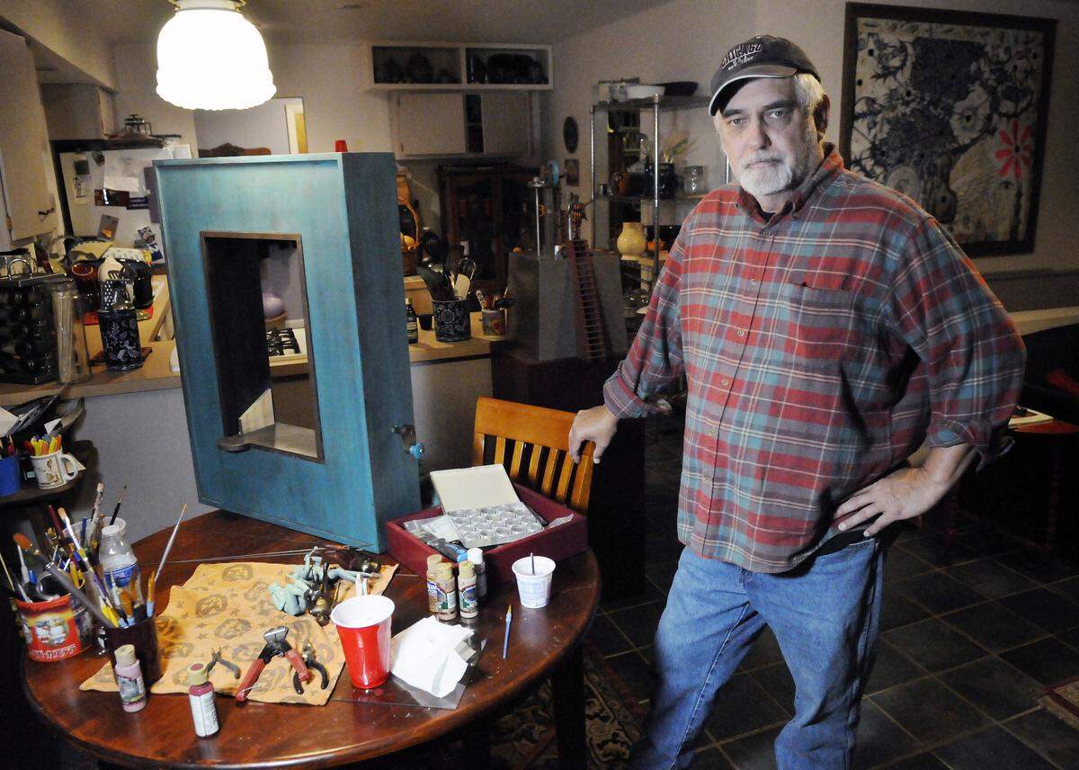 Artist Steve Armstrong does a lot of the work on his automata sculptures at the kitchen table of his Lexington home, as his basement workshop has become cluttered with bits and pieces of material he may use in future works. Photo by Tom Eblen | teblen@herald-leader.com