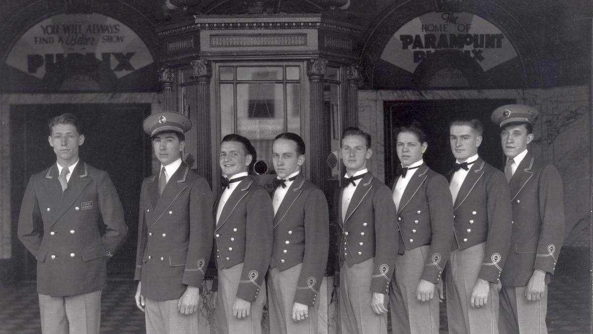 Kentucky Theatre ushers on May 30, 1931. The sign in the ticket booth behind the ushers says that admission prices were $.50 for adults and $.10 for children. During the weekend this photograph was taken, the Kentucky Theater hosted Smiling Ed McConnell, a popular radio star of the time. The theatre will celebrate its 100th anniversary in October.