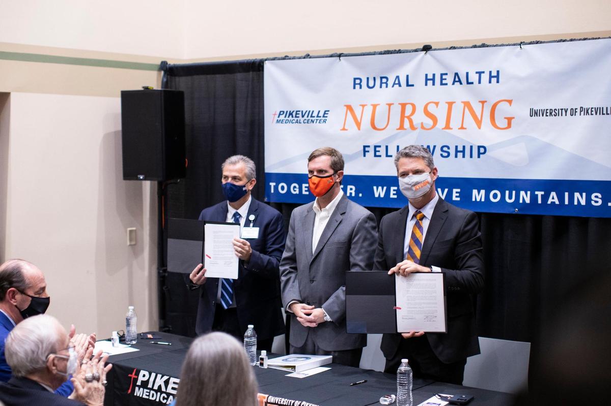 Gov. Andy Beshear, CEO of PMC Donovan Blackburn and Burton Webb, President of the University of Pikeville announces at a press conference announcing a rural health nursing fellowship at University of Pikeville in Pikeville, Ky., Thursday, December 2, 2021. PMC will offer graduates of University of Pikeville’s nursing program a job and will pay for their student loans over a three year period. The offer will depend upon the need for nurses at PMC.