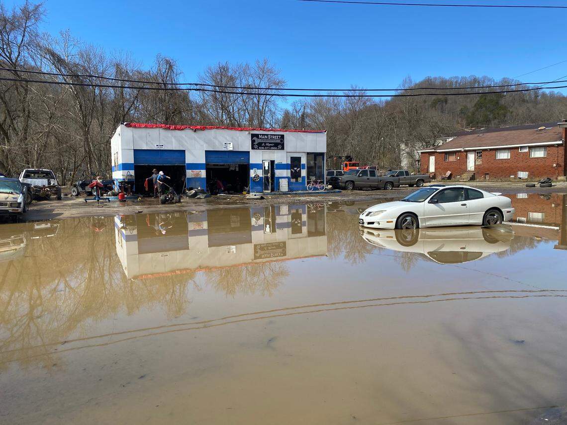 Jacolby and Denise Qualls clean up mud from their Main Street Performance and Repair shop in downtown Martin. The weekend flood destroyed the auto shop business and other parts of downtown.