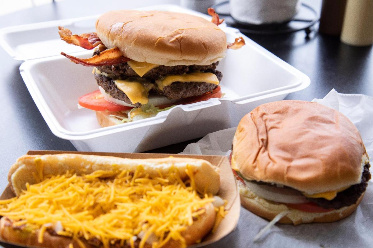 Cheese burgers, chili buns and a monster burger are just some of the cheap offerings from Pat’s Snack Bar in Manchester, Ky., Friday, April 15, 2022. The burgers are made to order and come as sliders, singles, doubles, triples or as one pound monster patties. The meat is delivered fresh from Booneville Shopwise.