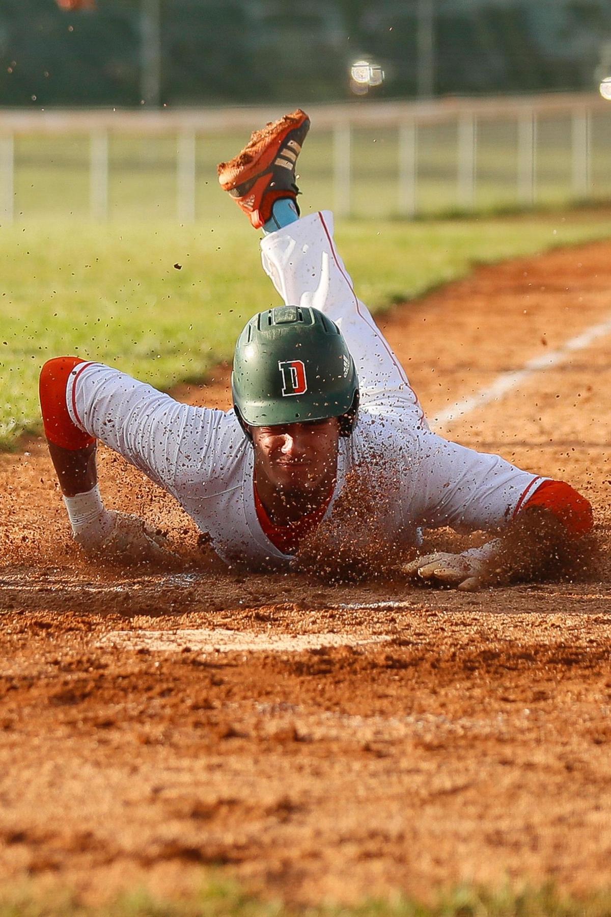 Dane Key (12) slides home to score a run for Frederick Douglass on Wednesday night.