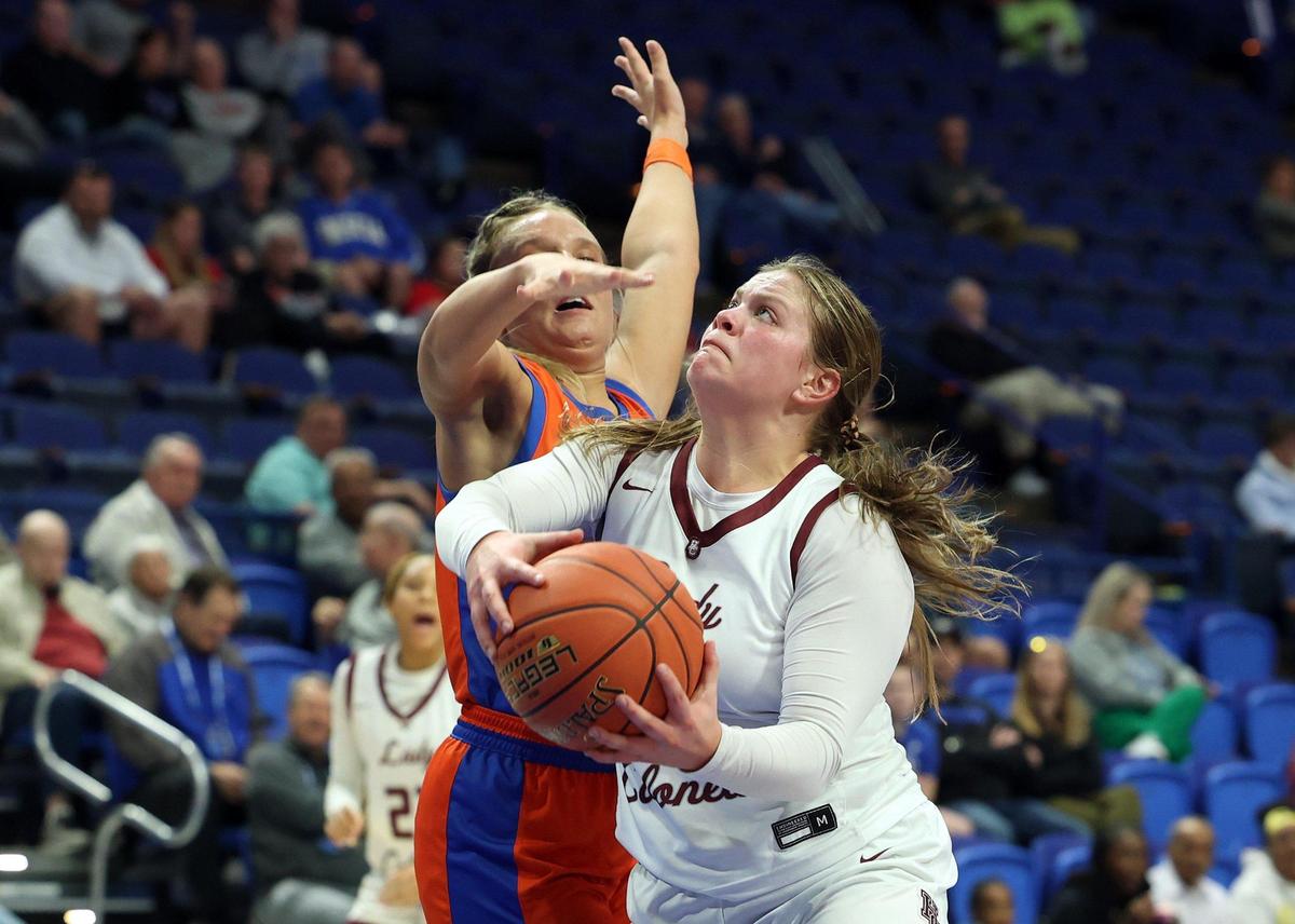 Henderson County’s Anna Kemp, right, shoots while pressured by Marshall County’s Skylar Waller during their first-round game in the Girls’ Sweet 16 on Thursday.