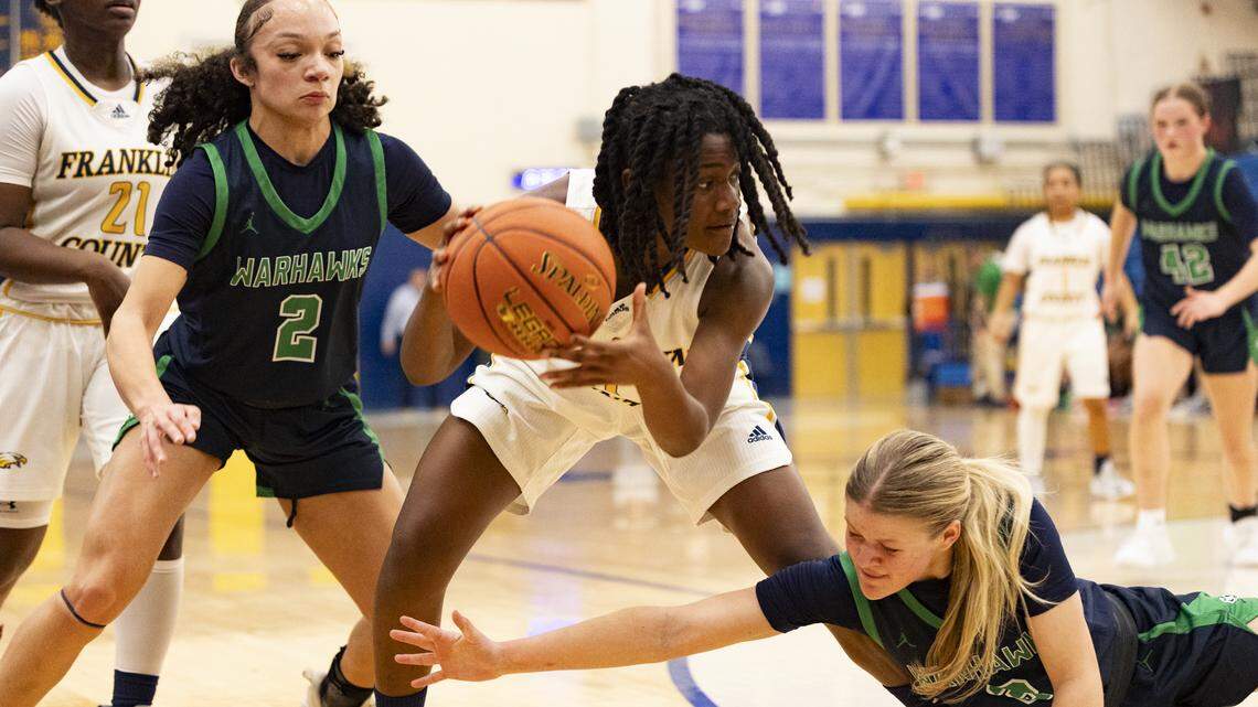 Franklin County’s La’Kyiah Taylor, center, battles through a double team by Great Crossing’s Maya Custard (2) and Kendall Kearney (3) during the Flyers’ 57-52 win on Tuesday at Franklin County High School in Frankfort.