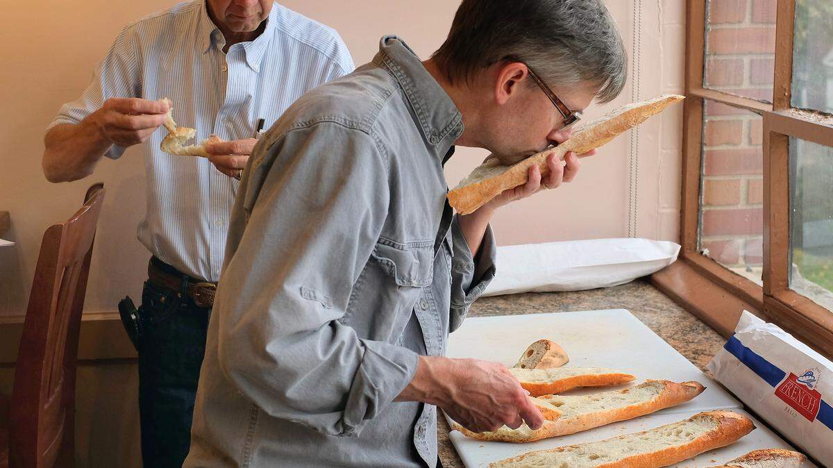 Jim Betts, front, and David Van Sanford of UK's College of Agriculture tested baguettes made with five varieties of wheat raised in Lexington. Betts checked aroma; Van Sanford checked texture and taste.   