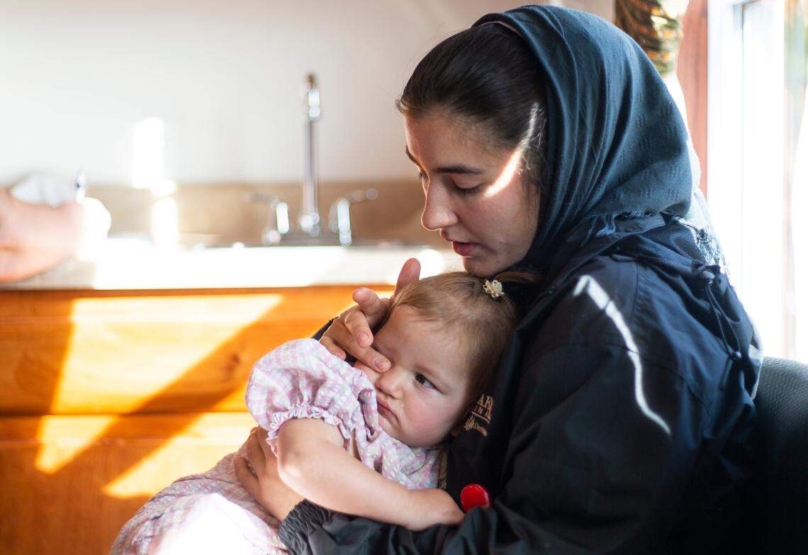 Horst holds Beverly and wipes a tear from her eye minutes after a Todd County public health nurse gave her two immunizations.