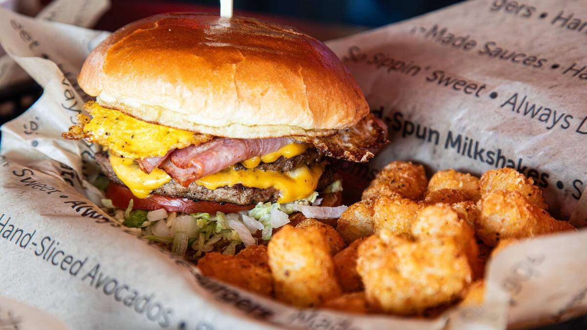 A ham and double-stacked cheeseburger with crispy golden tater tots made to order at the first Jaggers location on 2350 Norman Lane at Regency Center on August 5, 2025, in Lexington, KY.