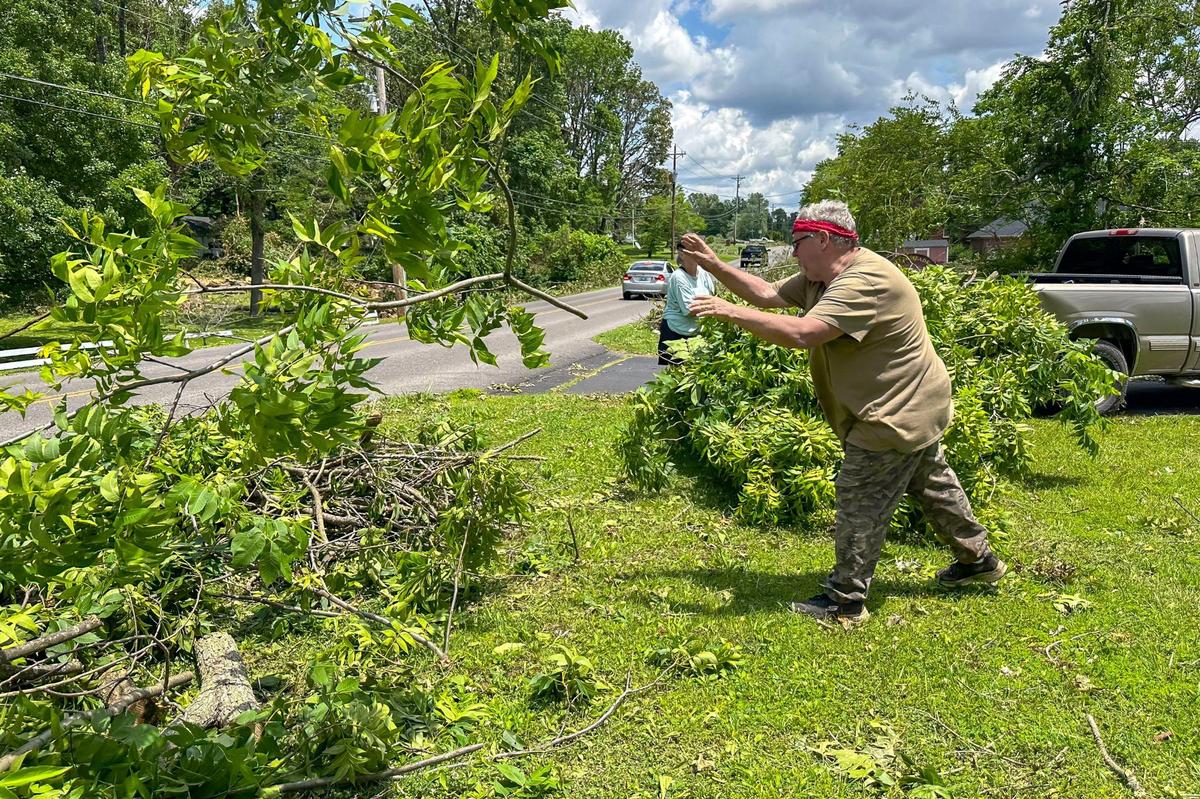 Steve Melvin, of Mayfield, clears storm debris at Ron and Chrissy Aldridge’s property in Mayfield, Ky., on Monday, May 27, 2024.