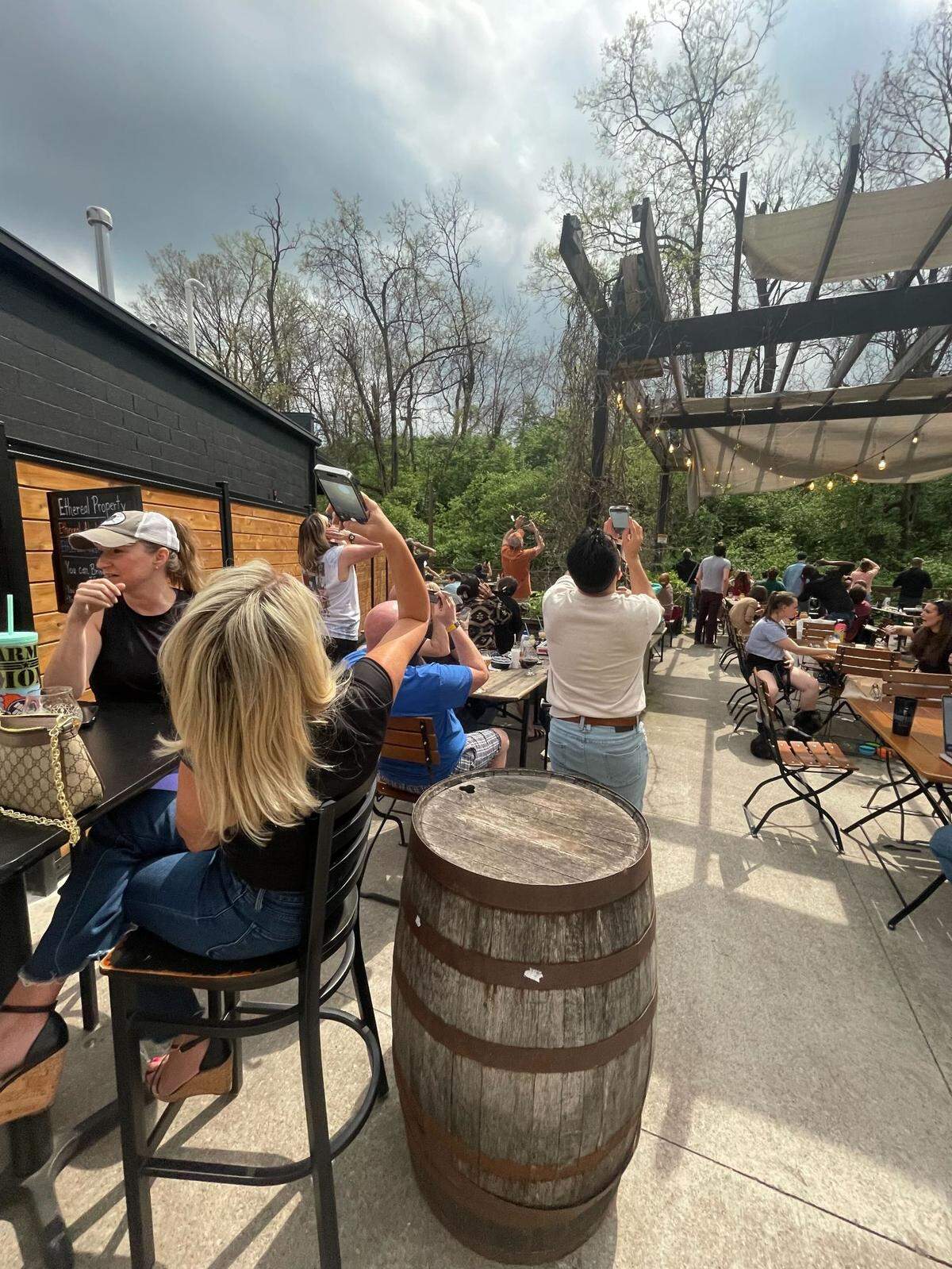 Eclipse observers at Ethereal Brewery in Lexington raised their glasses to catch a view.