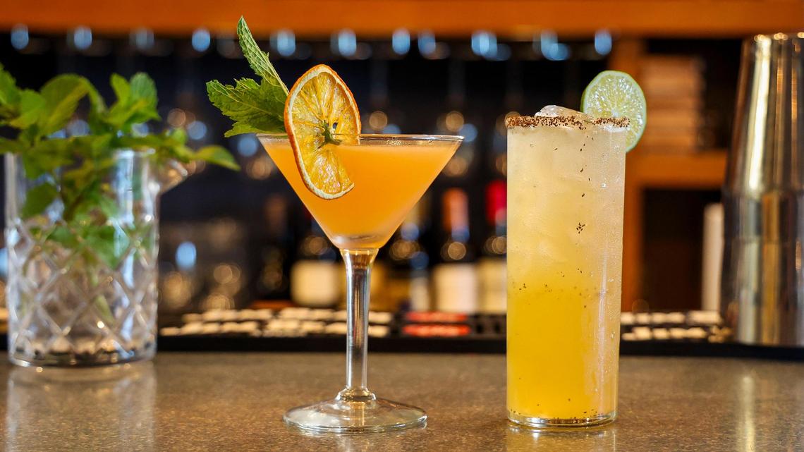 Two drinks from the bar at Azur Restaurant and Patio, shown Monday, May 20, 2025 in Lexington, Ky. At left, the Summer Cruise is made with rum, Mezcal, orange blossom honey, peach preserves, bitters, saline solution and absinthe. And at right, the Garden Party Margarita is made with vinegar, sugar, peppers, agave syrup, tequila, lime juice and with a celery salt rimmed line.