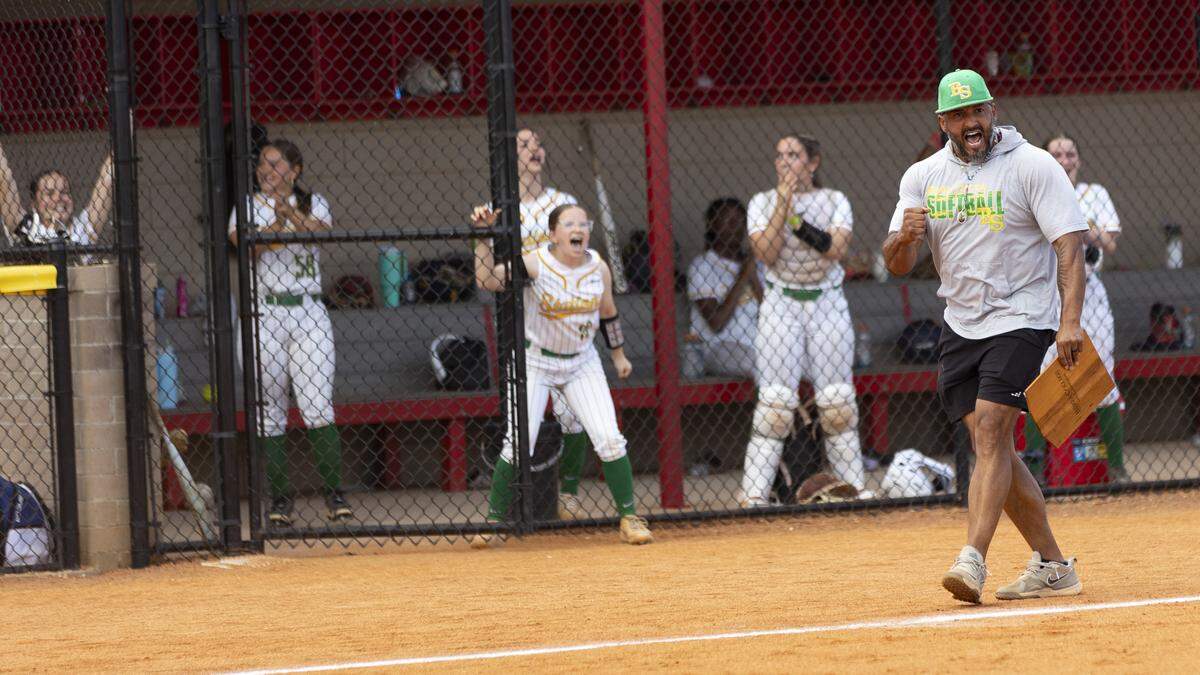 Bryan Station softball coach Hector Urbaneja celebrates Karsyn Rockvoan’s RBI-single during the Defenders’ 5-2 win over Frederick Douglass in the 42nd District Tournament semifinals at Scott County High School on Tuesday in Georgetown.