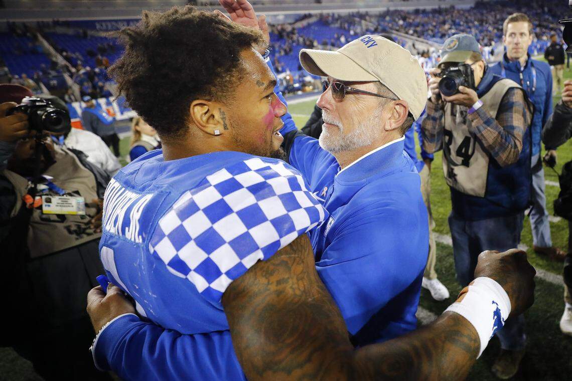 Kentucky quarterback Lynn Bowden hugged offensive coordinator Eddie Gran after Saturday night’s win at Kroger Field.