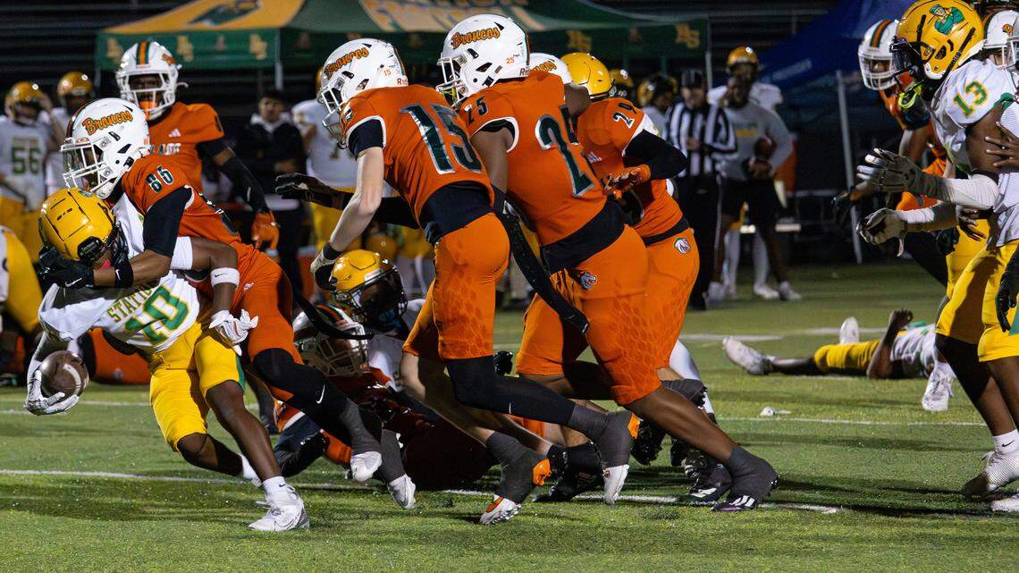 Broncos WR Kane Bell Pointer (86), DB Toby Robinson (15), LB Maddox Jones (25), and DB Ibrahim Najl (29) stopped Defenders WR Brayden Payne (10) from gaining yards during the Class 6A second round playoff game between Bryan Station and Frederick Douglass on Nov. 14, 2025, in Lexington, Ky.