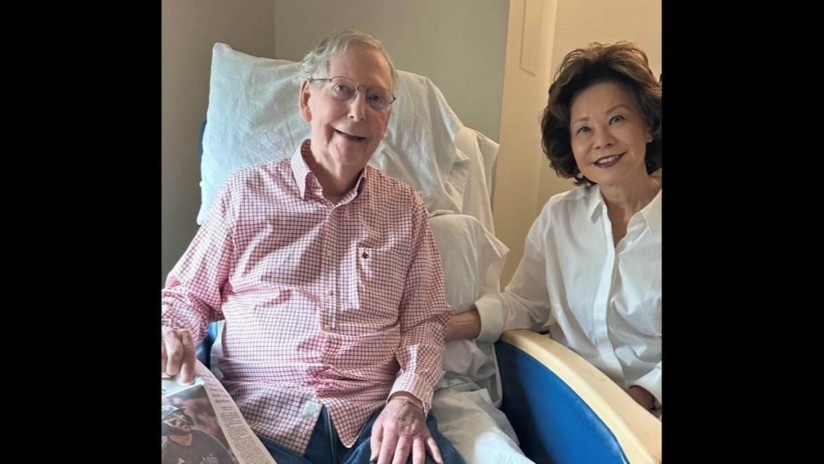 Kentucky Senator Mitch McConnell poses with his wife, Elaine Chao, in a picture from the hospital bed after weeks of rumors circulating about his health.