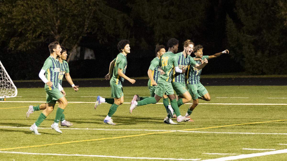 Bryan Station’s Lincoln Wallingford, second from right, celebrated with teammates after his goal with 29.1 seconds left in the second overtime won the Defenders’ first-round game against Bishop Brossart in the KHSAA Boys State Soccer Tournament at Bryan Station High School on Monday.