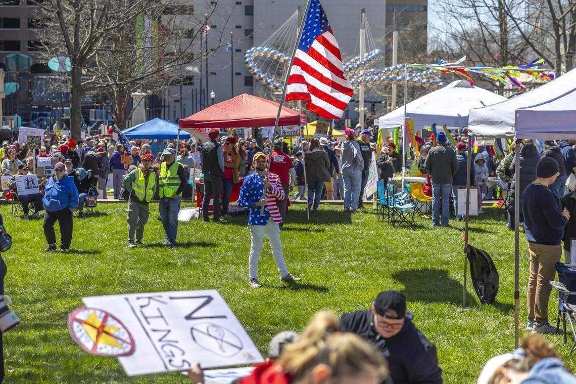Tyler Clark of Lexington waves a U.S. flag during a No Kings protest in downtown Lexington, Ky., on Saturday, March 28, 2026.