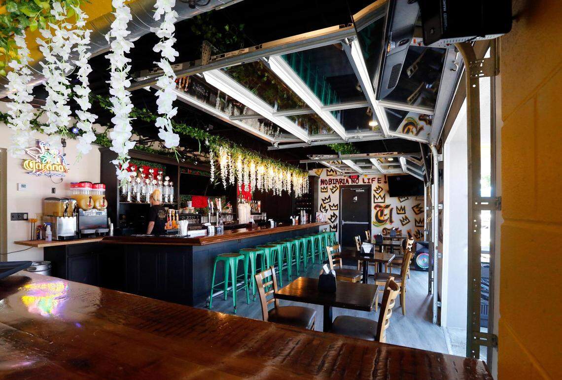 The dining room and bar area at El Cid includes garage doors that open to let fresh air in.