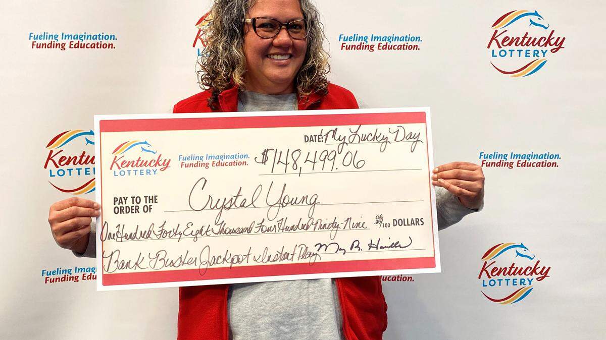 Crystal Young of Louisville poses recently with a big check after winning more than $148,000 playing a Kentucky Lottery Instant Play game.