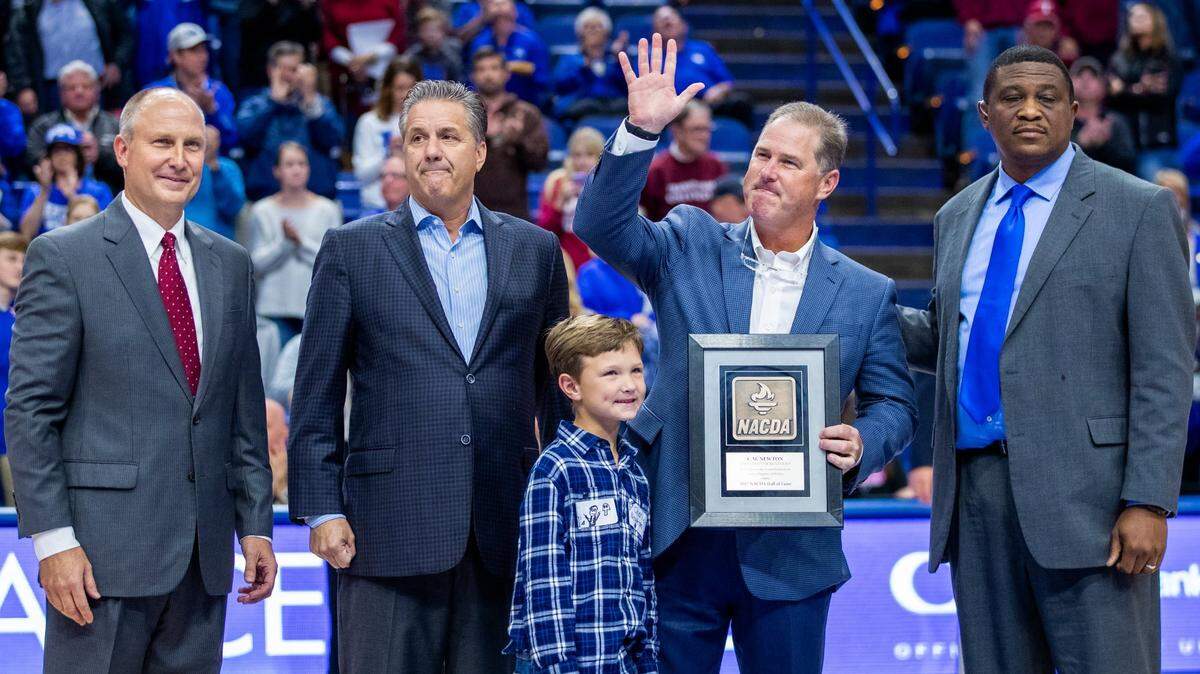 Martin Newton, second from right, took part in a ceremony to honor his father, C.M. Newton before an exhibition game against Transylvania on Oct. 26, 2018. Also pictured were Transylvania Coach Brian Lane, Kentucky Coach John Calipari, Charlie Newton (Martin’s grandson) and then-deputy director of athletics DeWayne Peevy.