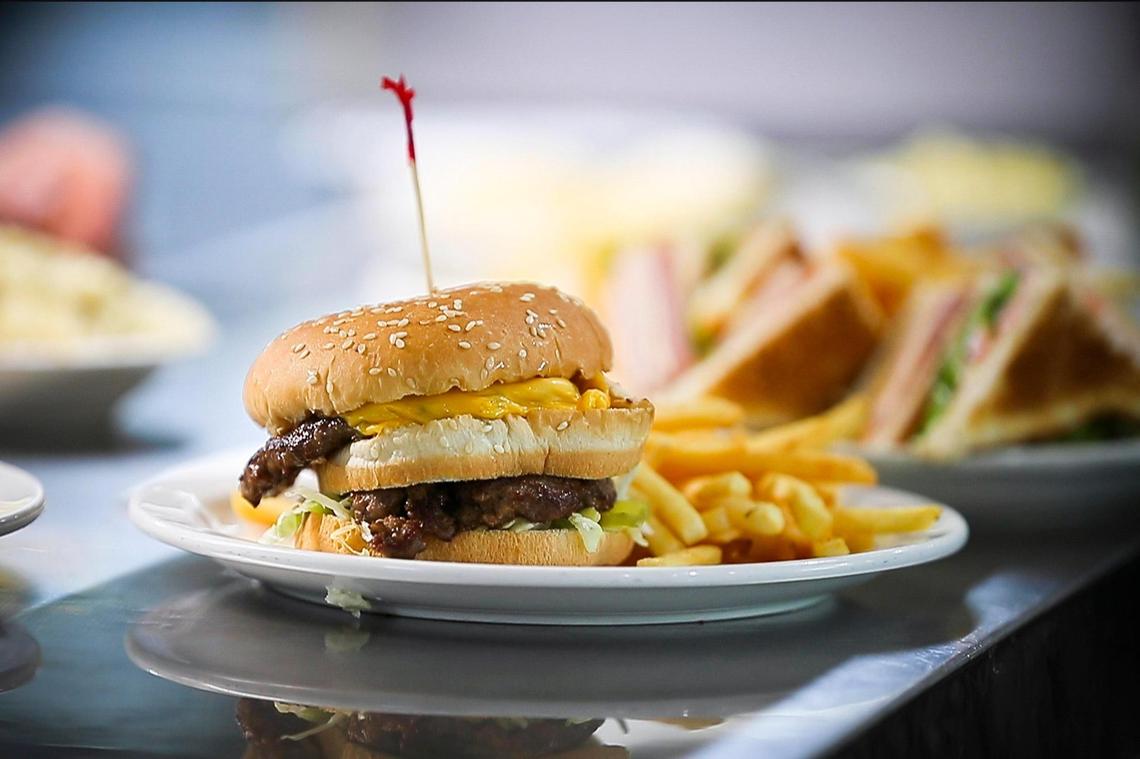 The J-Boy plate, a double decker burger with cheese, lettuce, pickles and a special sauce and served with fries and cole slaw at Jerry’s Restaurant in Paris.