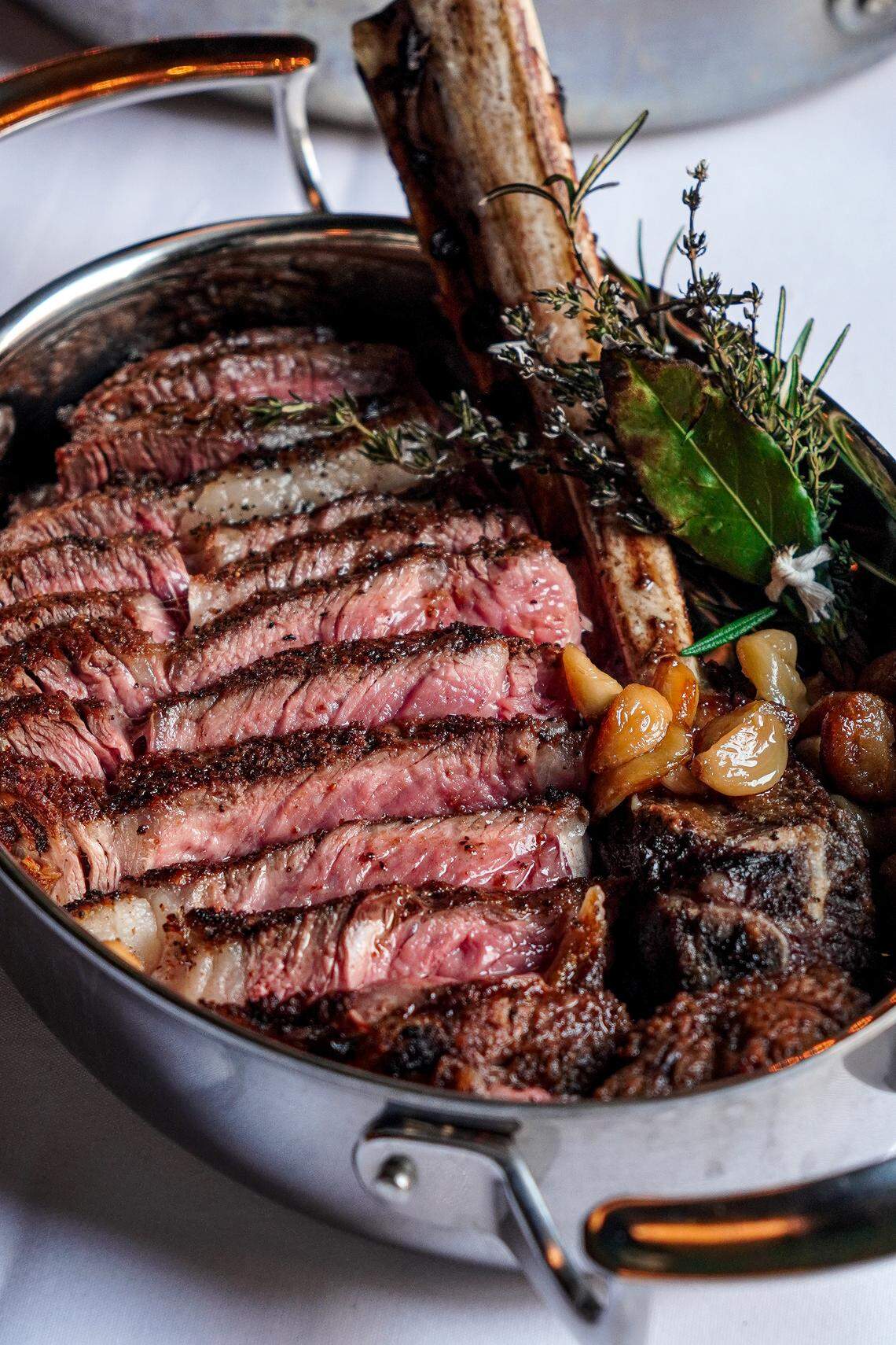 The bone-in tomahawk ribeye at Silk’s Steakhouse located inside The Aldenberg Hotel in Versailles, Ky. The prime steak comes with two sides for $185.