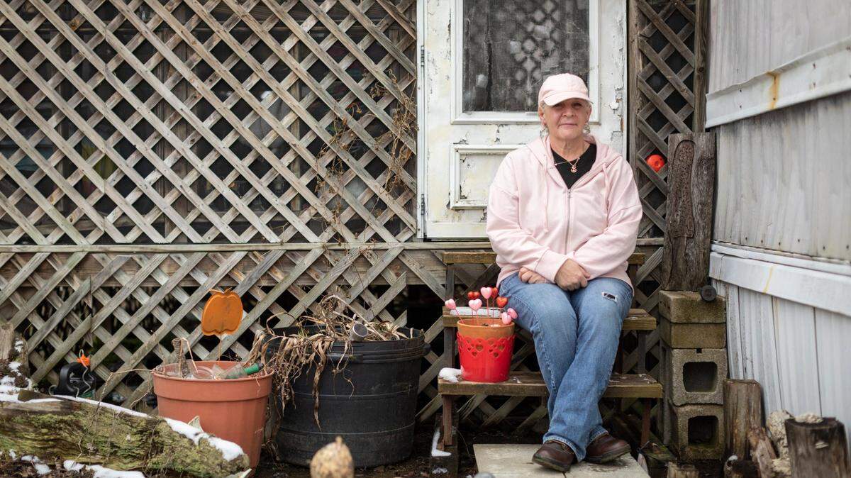 Mindy Davenport poses for a portrait outside her trailer at the North Fork Moblie Home Park in Morehead.