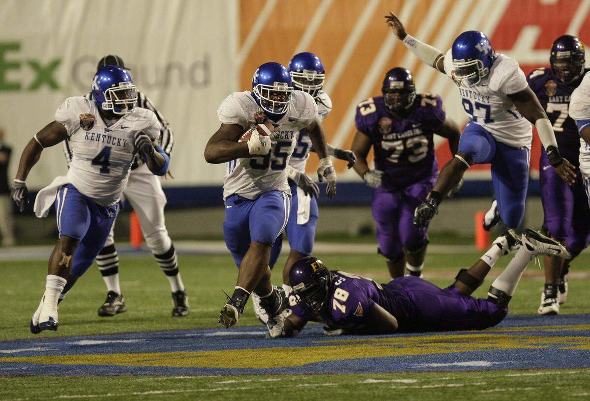 Kentucky's Ventrell Jenkins, second from left, carried the football on what became the 56-yard, fumble-return touchdown that gave Kentucky a 25-19 win over East Carolina in the Liberty Bowl at the end of the 2008 season.