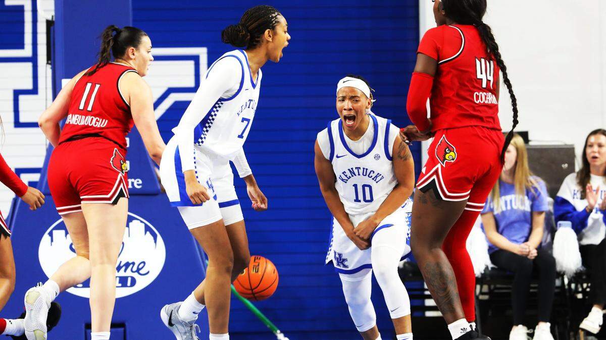 Kentucky forward Teonni Key (7) and guard Dazia Lawrence (10) celebrate a layup during Saturday’s game against Louisville at Memorial Coliseum.