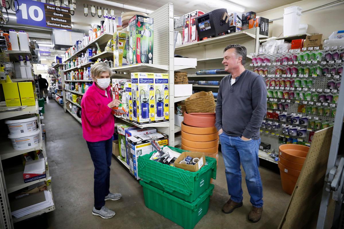 Jane Miller jokes Thursday with Chevy Chase Hardware owner John Justice as she shops. Miller has been a Chevy Chase Hardware customer for over 40 years.
