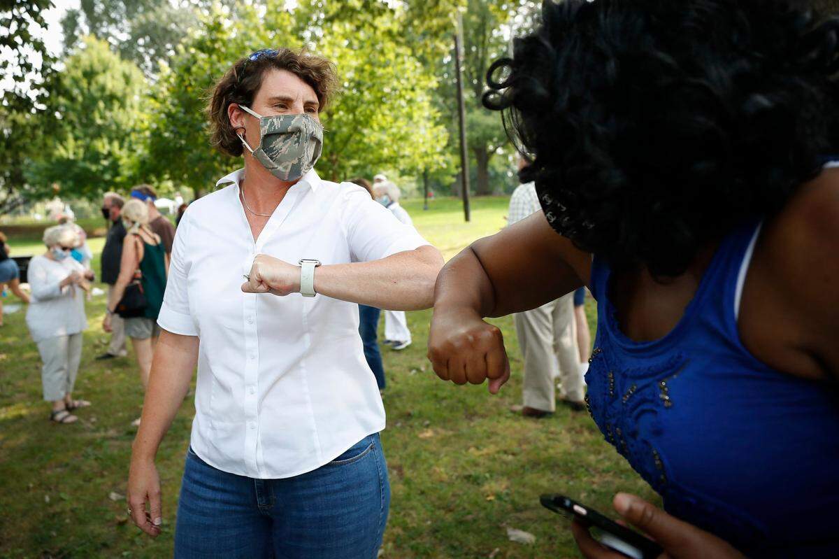 Democratic Kentucky Senate candidate Amy McGrath greets Sandra Krajewski, of Lexington, Ky., during a campaign stop at Woodland Park in Lexington, Tuesday, Aug. 25, 2020.