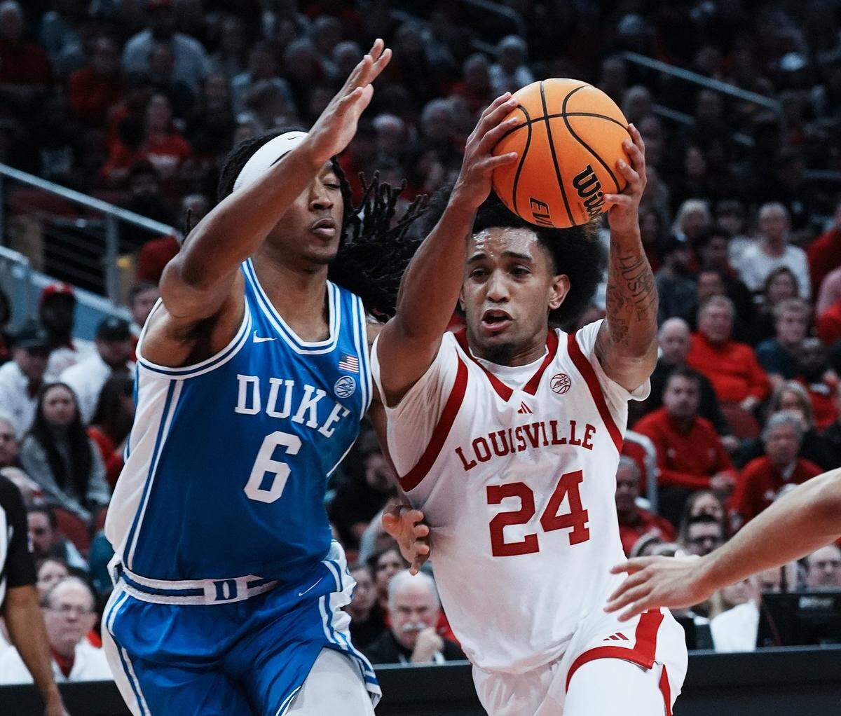 U of L’s Chucky Hepburn (24) drives against Duke’ s Maliq Brown (6) during their game in Louisville on Sunday night.