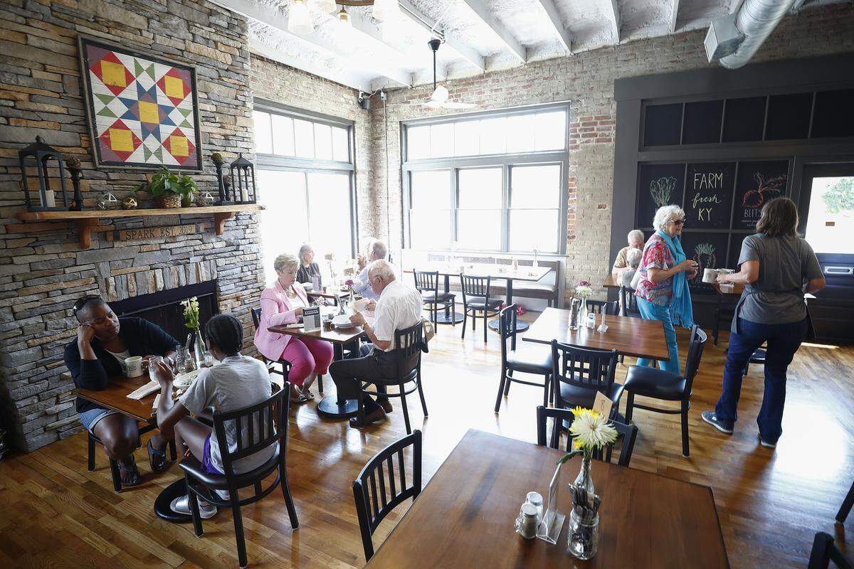 People gather for lunch at Spark Community Cafe in Versailles, Ky., Sunday, June 23, 2019. Spark Community Cafe operates on a pay what you can scale and offers people an opportunity to volunteer time in exchange for their meal.