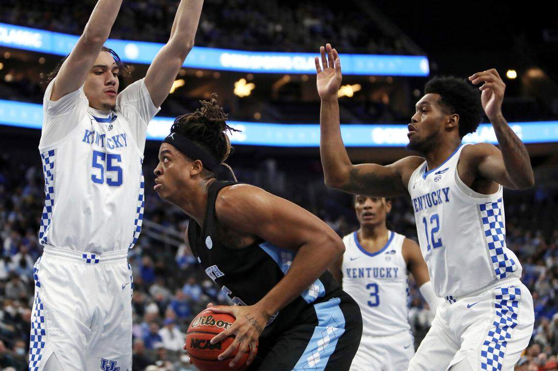 North Carolina’s Armando Bacot (5) goes for the rebound against Kentucky’s Lance Ware (55) and Keion Brooks (12) during the first half in Las Vegas on Saturday.