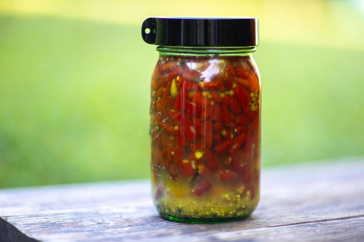 Peppers grown by Matt Sigler ferment in a bottle in his backyard.