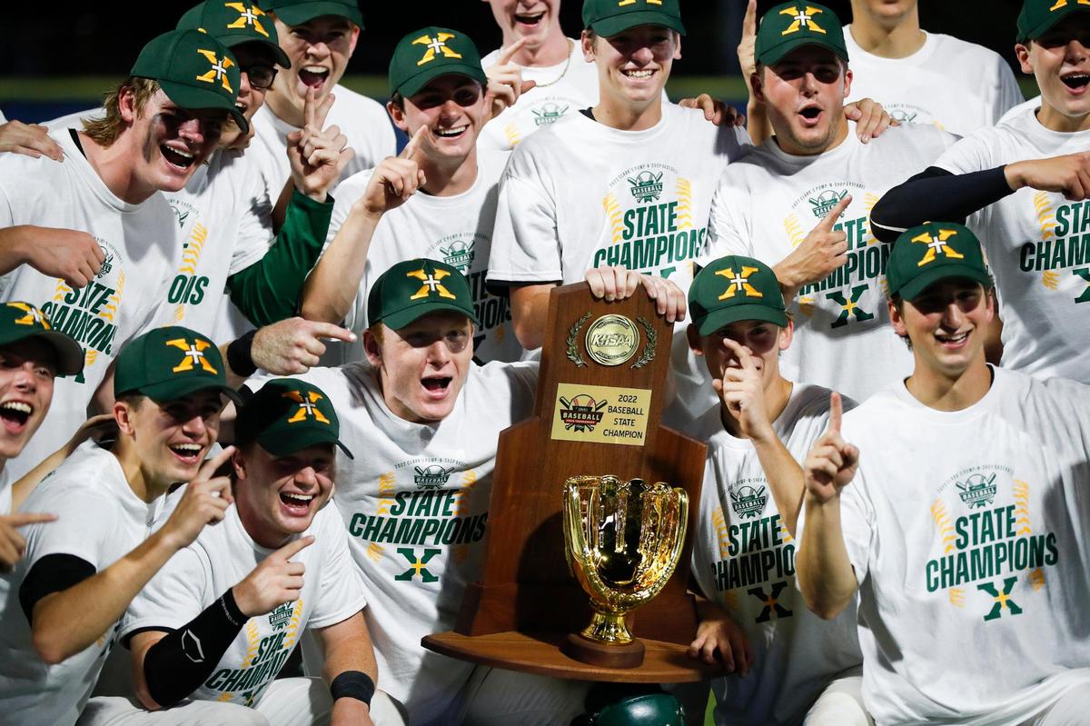 The St. Xavier Tigers celebrate defeating the Russell County Lakers 11-1 to win the KHSAA state baseball championship game at Kentucky Proud Park on Saturday.