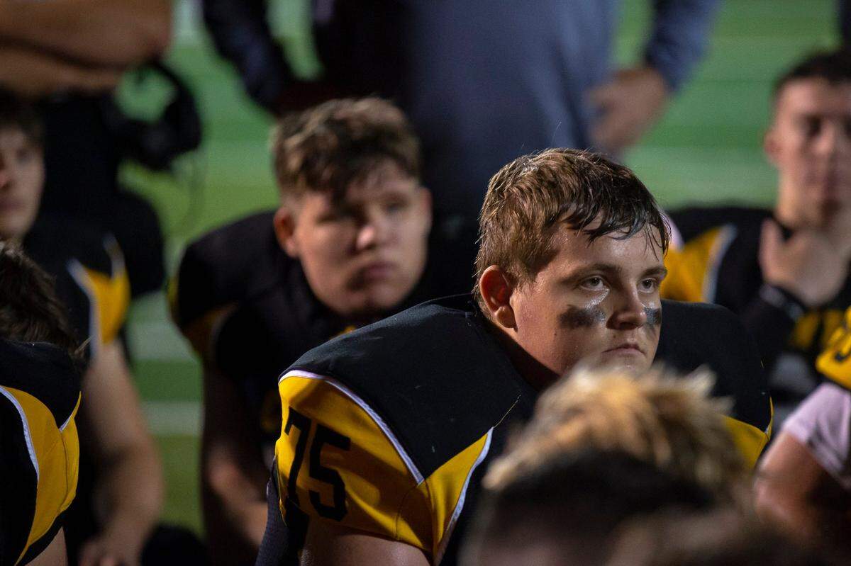 Johnson Central’s Hudson Lewandoski, center right, and his teammates listened to interim head coach Steve Trimble after their team defeated Clay County 42-6.