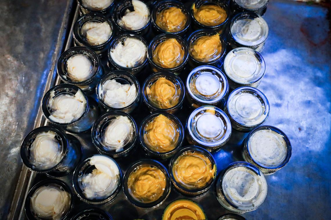 Condiment containers wait for packaging Saturday at Malone’s Lansdowne. All orders at Malone’s and Drake’s will be delivered to customers curbside.