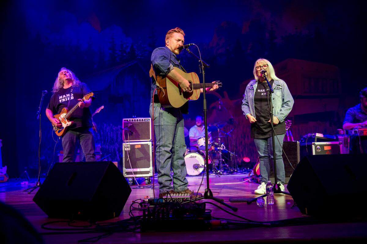Tyler Childers, center, performs with David Prince, left, and Teresa Prince Friday, Feb. 7, 2020, at the Ryman Auditorium in Nashville, Tenn. The two Lawrence County, Ky. school teachers have known Childers since he was a child and he wanted to honor them with a Ryman Audtiorium performance. The performed the Teresa Prince original ‘That Thing You Said.