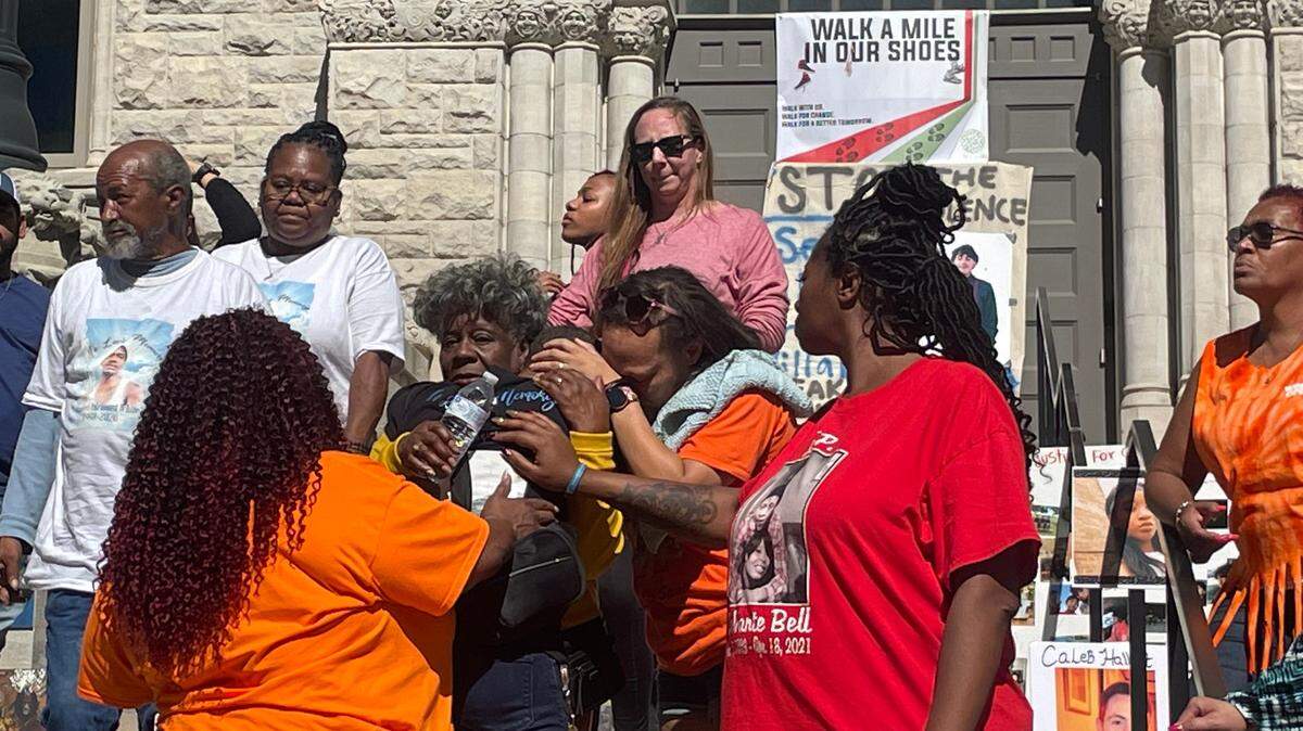 Members of ‘We are Survivors’ gun violence prevention group, hug each other outside of the courthouse on Sunday afternoon.