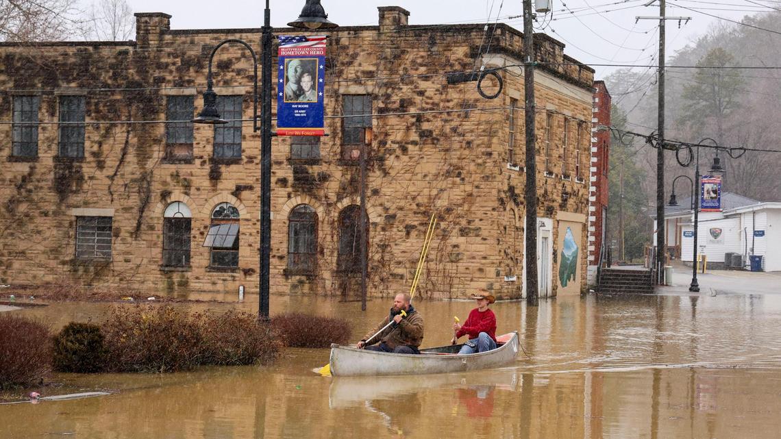 Jordan Wade, left, and Kelvin Gabbard made their way through the flooded waters of closed Main Street after high flood waters after severe overnight rain hit Beattyville, Feb. 14, 2025 in Lexington, Ky. The pair were delivering groceries to friends stranded due to the closed road. The photo won first place for breaking news photography from the Kentucky Press Association.