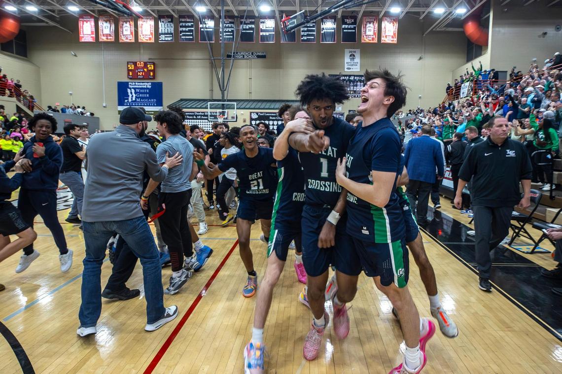 Great Crossing’s Vince Dawson (1) is surrounded by teammates after scoring a basket at the buzzer to beat Lexington Catholic during the boys 11th Region Tournament championship game at Paul Laurence Dunbar High School last March.