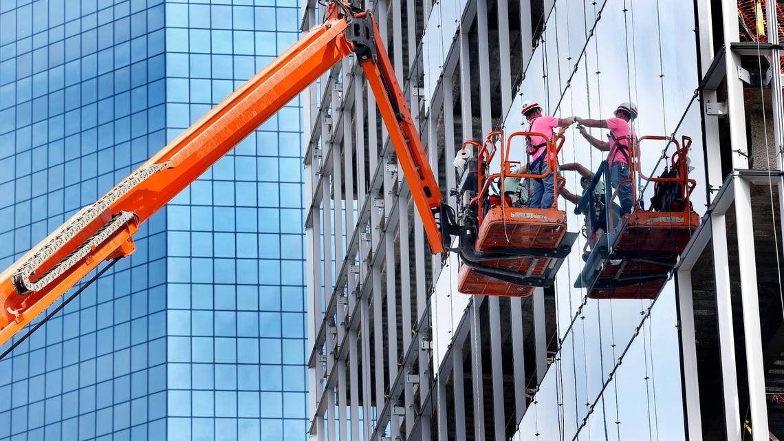 Construction workers installed glass panels Wednesday morning at the One City Center office tower under construction at the corner of West Vine Street and South Limestone. City Center was formerly known as CentrePointe. Webb Companies Project Coordinator Ralph Coldiron said that 4,222 pieces of glass will be needed to wrap the building.