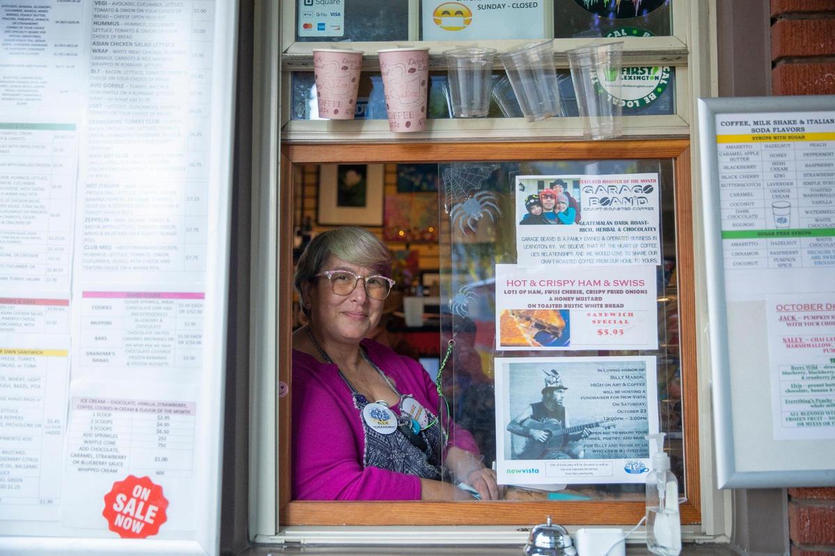 Ellie Harman, High on Art & Coffee co-owner, poses for a portrait at the shop’s order window in Lexington, Ky., on Thursday, Oct. 21, 2021. Part art gallery, part cafe, at the intersection of creativity and coffee, it’s one of Lexington’s true hidden gems.