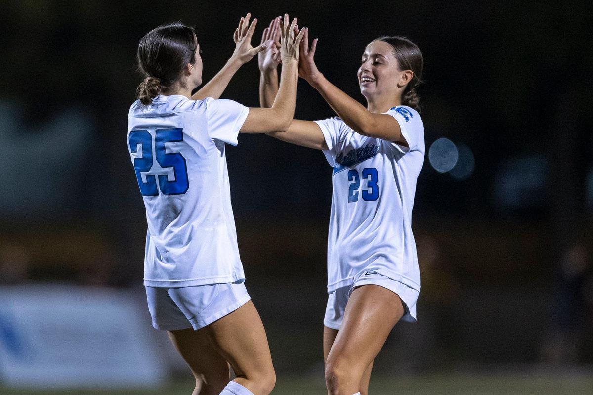 Lexington Catholic’s Sara-Kate Barnes (25) and Izzy Skinner (23) celebrate a Knights goal against North Laurel during the Kentucky high school girls state tournament semifinals at Paul Laurence Dunbar on Wednesday.